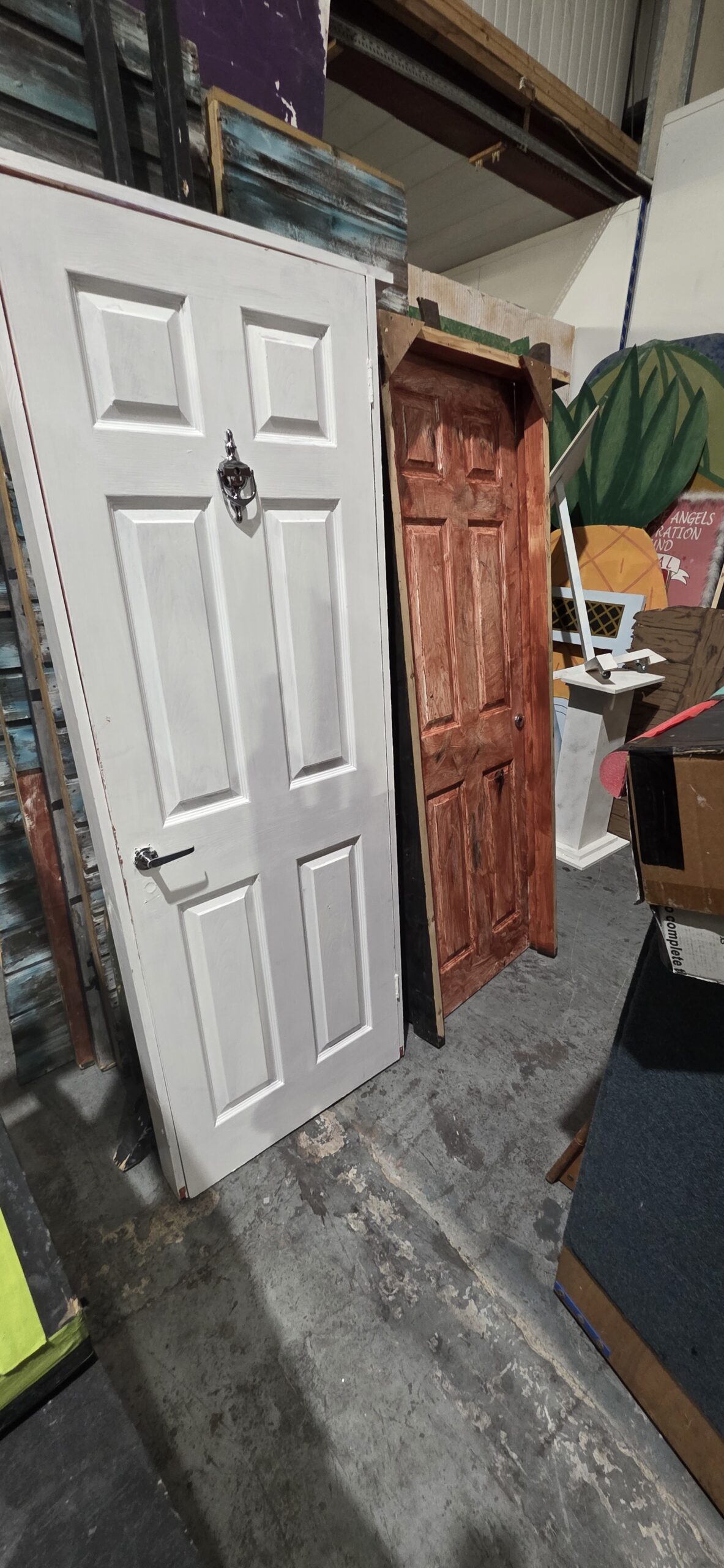 Hire stock — white panelled door and aged-timber door, ready for hire